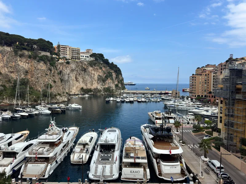 Elevated view of Fontvieille port from Le Giorgione apartments in Monaco, with the Rock of Monaco to the left and the open Mediterranean beyond the harbour mouth