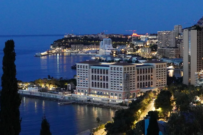 Golden hour panoramic view of Monaco from Avenue de Varavilla with warm sunset light over the harbour and Monte-Carlo skyline