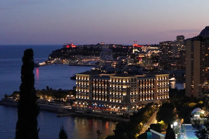 Night panorama of Monaco from Avenue de Varavilla with city lights across the harbour, Monte-Carlo towers and the Rock reflected across the principality