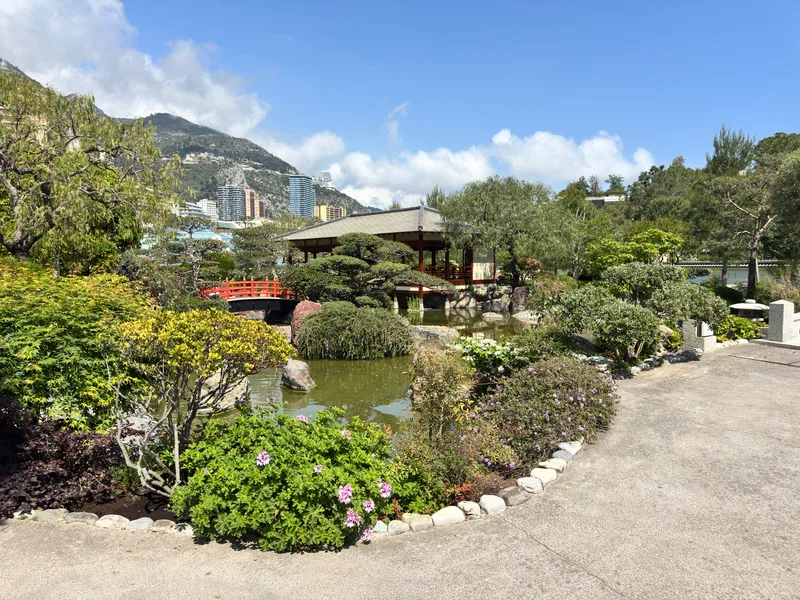 The tranquil picnic lawns and open grass areas within Monaco's Japanese Garden, a rare open green space in the principality's densely built urban fabric